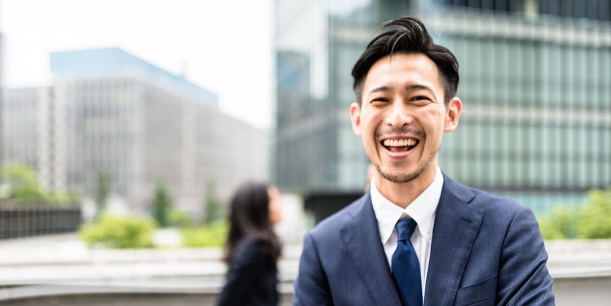 smiling professional man outside office building