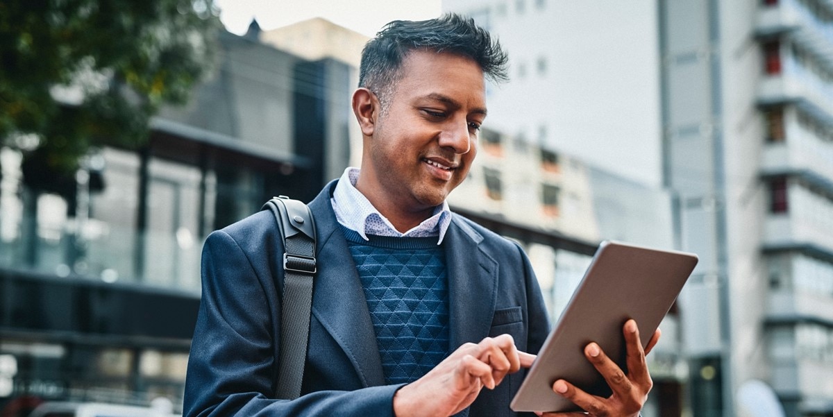 travelerusing tablet, outside of building