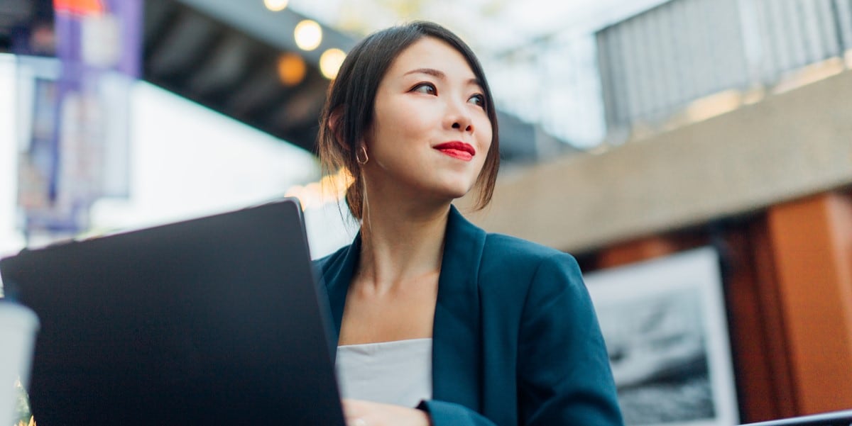 professional woman working at desk with laptop